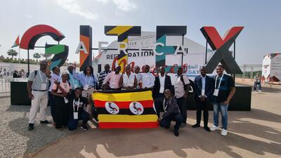 Group of African tech entrepreneurs pose in front of GITEX Africa sign