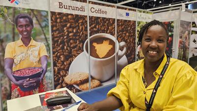Burundi coffee producer smiles at display at trade fair