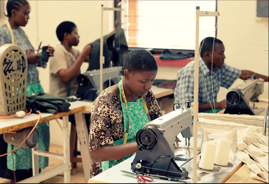 Woman at sewing machine in Kenyan designer studio