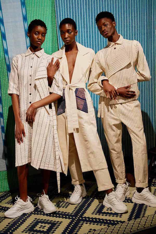 Three models in African fashion designs
