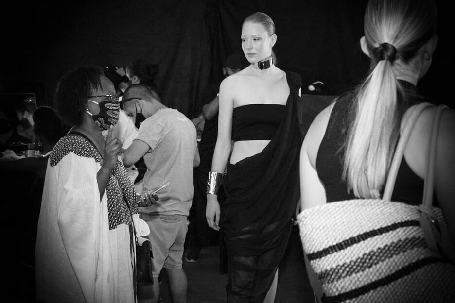 Fashion designer backstage with model