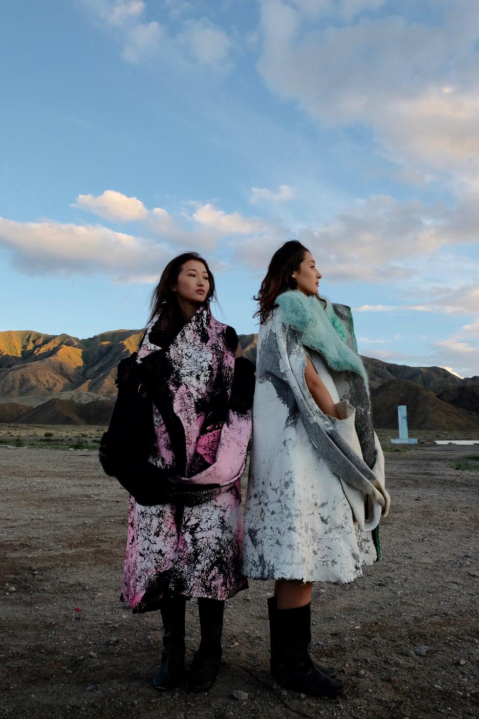 Two female models wear felt coats