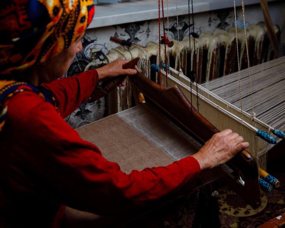 Weaver working camel hair on a loom