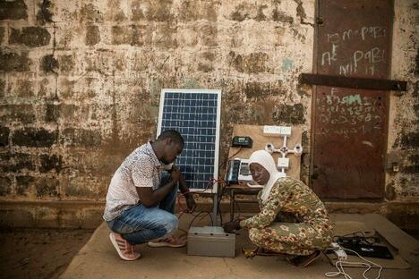 Fatou Badjie (à droite) a terminé sa formation en installations solaires et dirige à présent avec succès sa propre entreprise en Gambie.