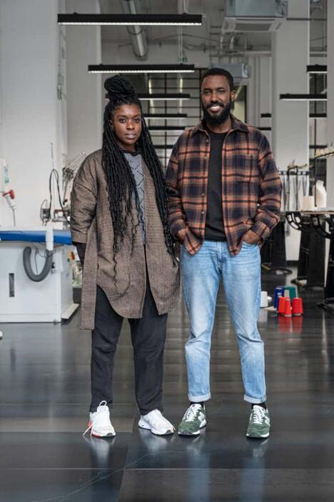Two Kenya designers stand in fashion studio