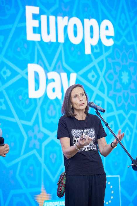 Ambassador speaks in front of Europe Day banner