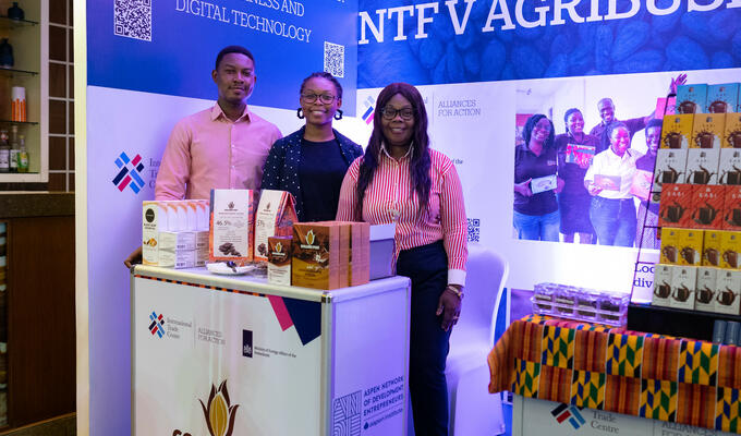 Three Ghanaian entrepreneurs stand at ITC booth at trade fair