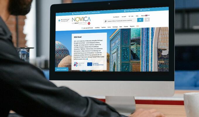 Man looks at computer screen displaying the ITC Novica Silk Road website
