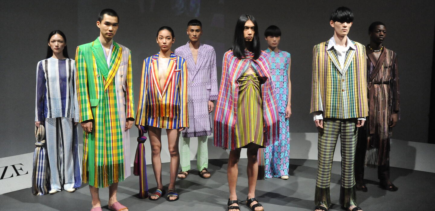 Models at Tokyo Fashion showcasing colourful and culturally rich "FACE A-J" clothing