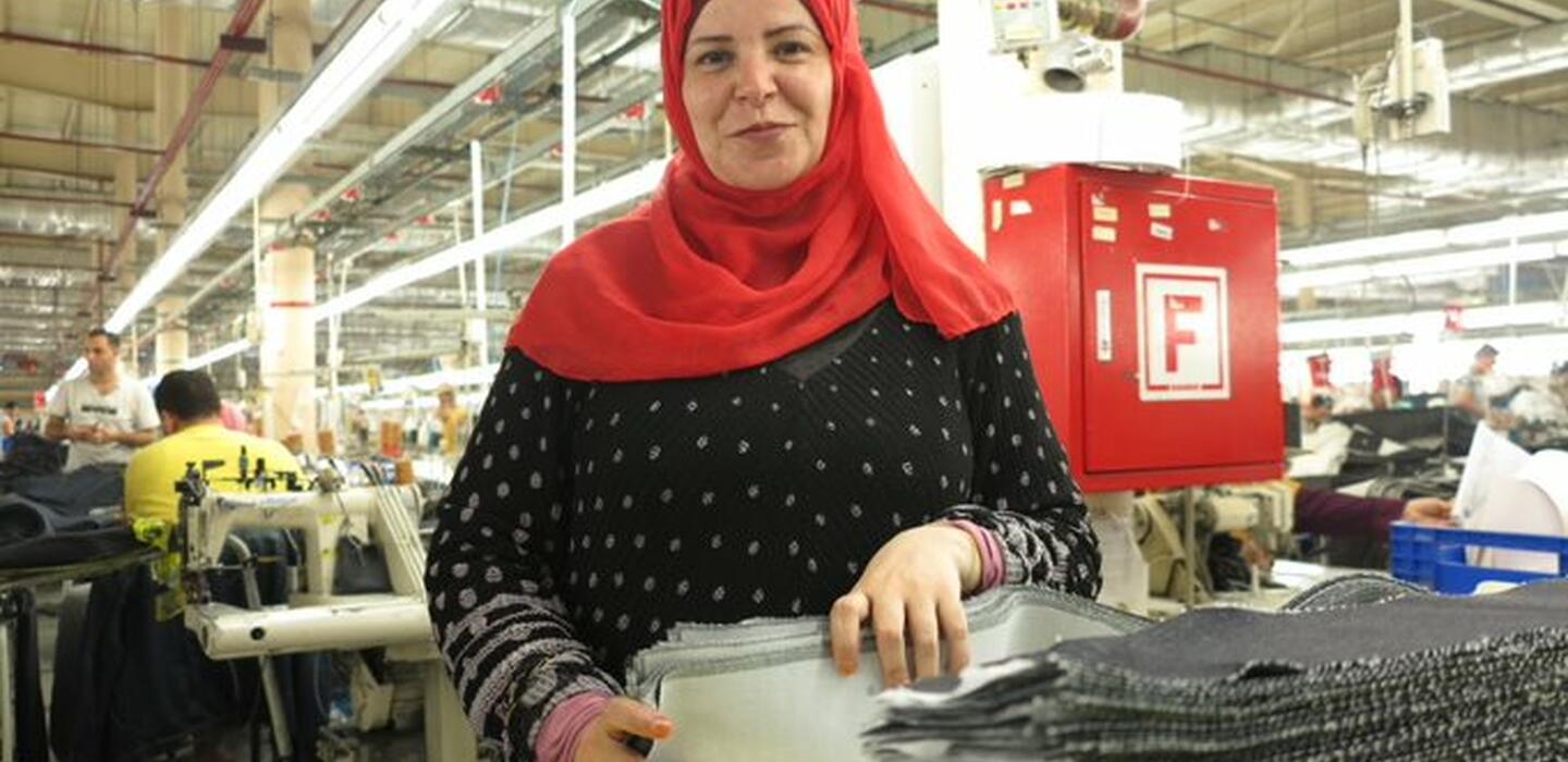 Woman working in a jeans textile company. 