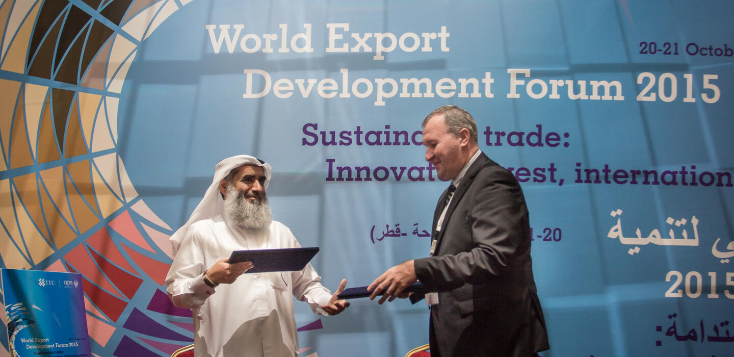 Two men on stage at the WEDF 2015 in Doha, Qatar