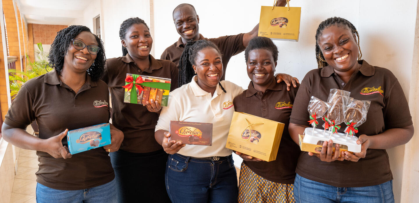 Group of staff hold boxes of chocolates