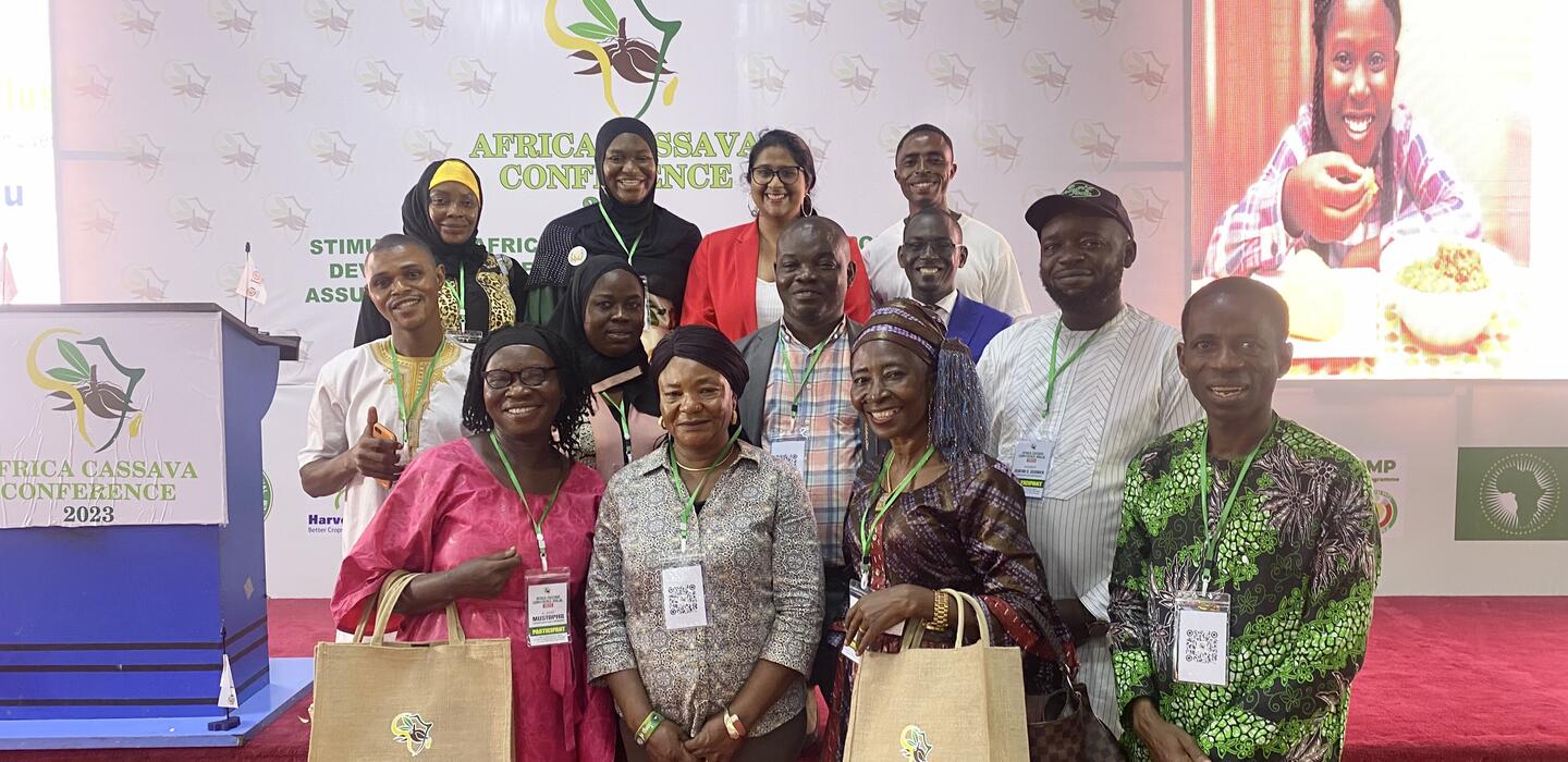 Group of small business owners pose with bags in conference centre