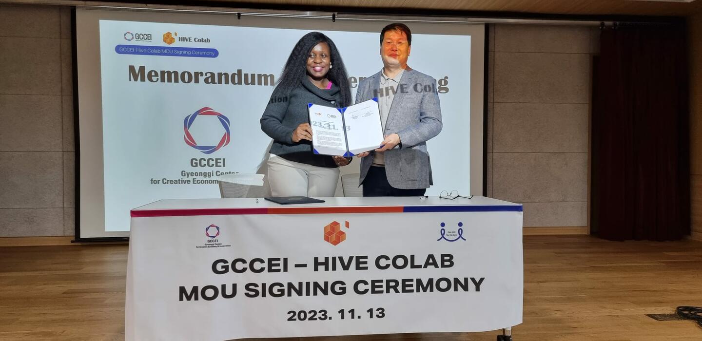 Barbara Mutabazi, co-founder of the Hive Colab, and Jonghwi Lee, General Director of the Gyeonggi Creative Economy Innovation Centre, hold copies of the memorandum of understanding