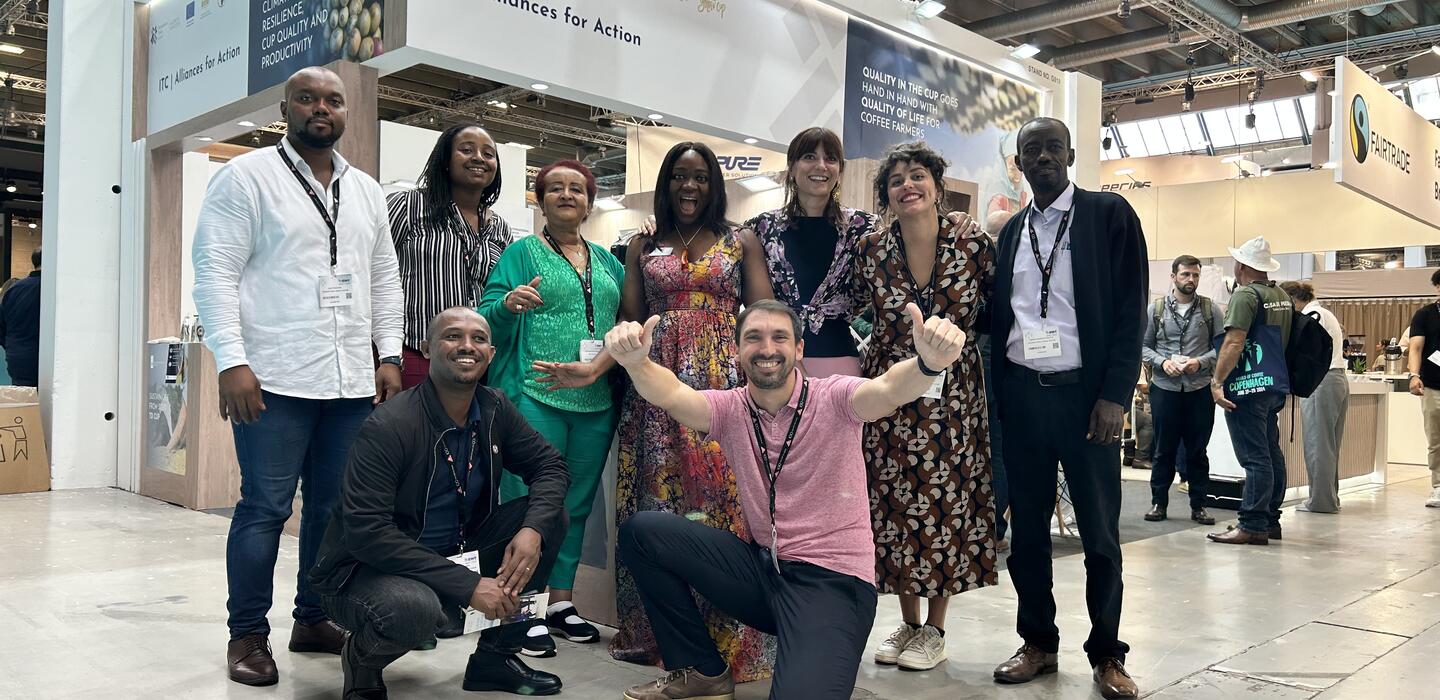 African coffee producers pose next to their stand at the World of Coffee in Denmark