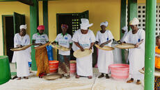 Women sort rice in baskets