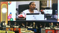 ITC Executive director Pamela Coke-Hamilton shown on large projector screen speaking to attendees of the G20 meeting in Jaipur, India