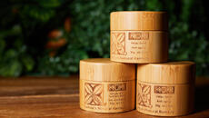 Three containers of anti-aging cream in bamboo looking packages