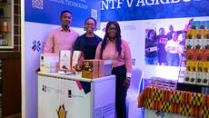 Three Ghanaian entrepreneurs stand at ITC booth at trade fair