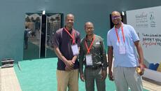 Three African entrepreneurs stand outside the conference centre hosting the Saudi Food Show